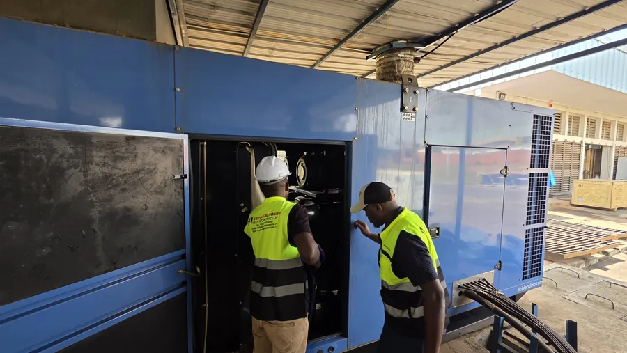General Power engineers in personal protective equipment servicing a standby generator