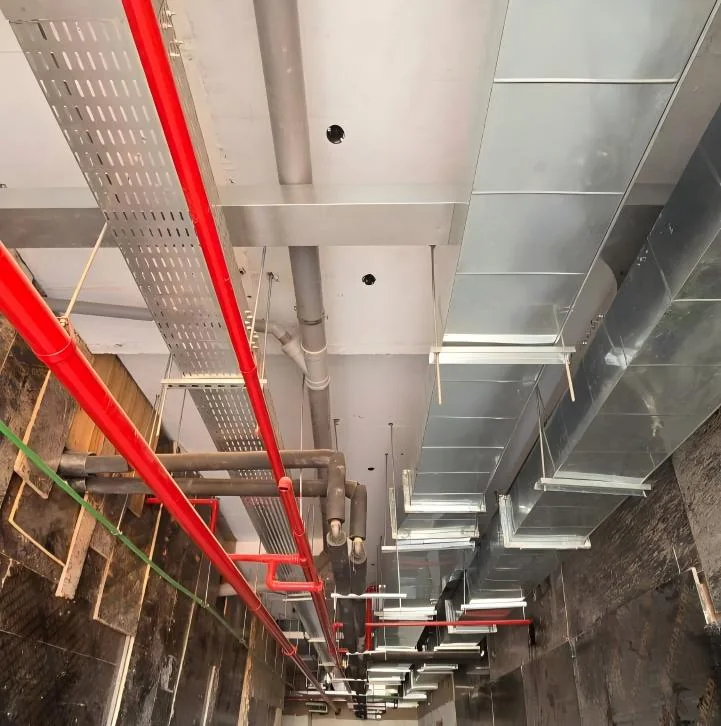 Integrated MEP services corridor at the Rwanda Heart Center — fire main, cable containment and ductwork installation